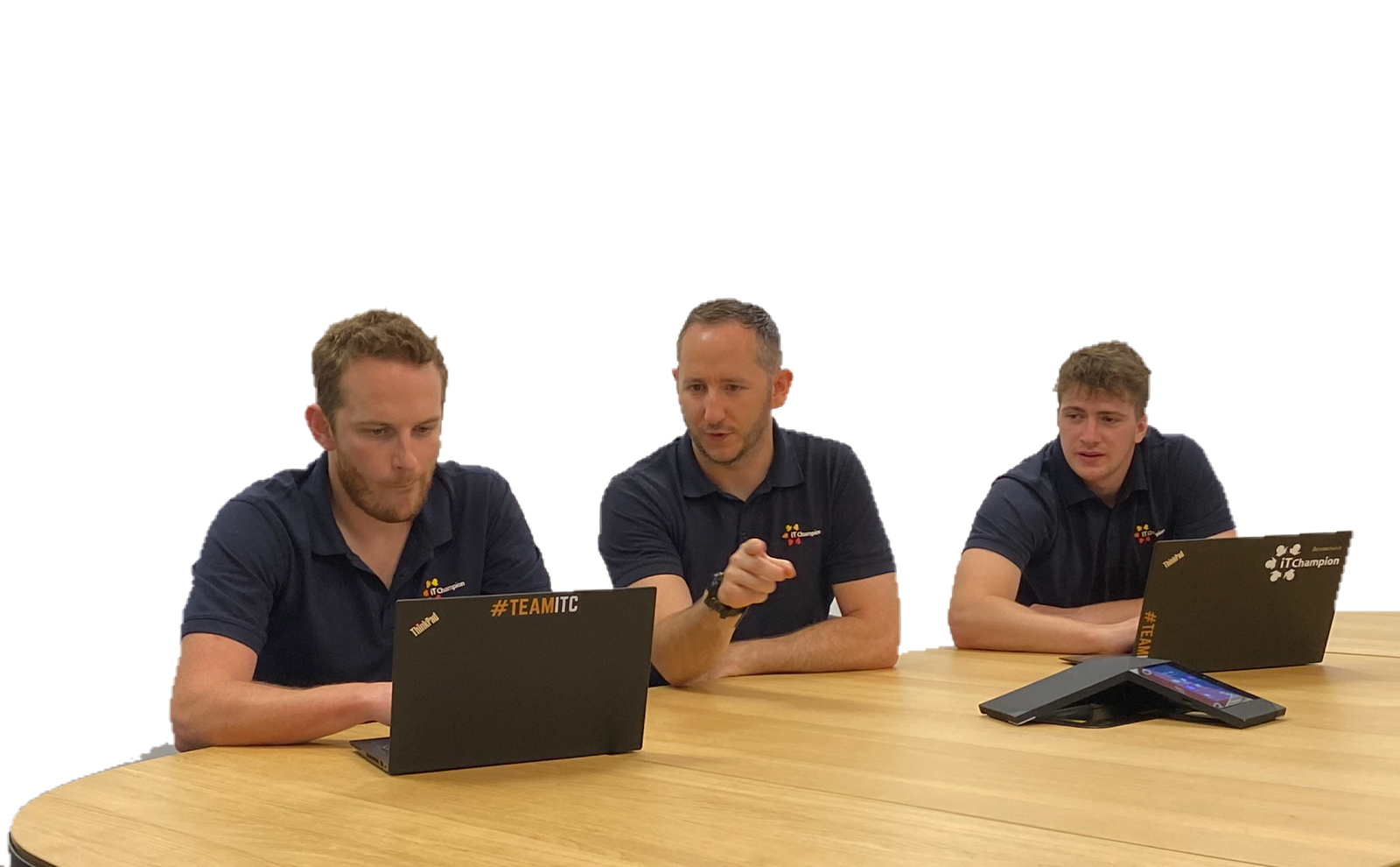 Three IT Champion experts sitting at a desk looking at a laptop